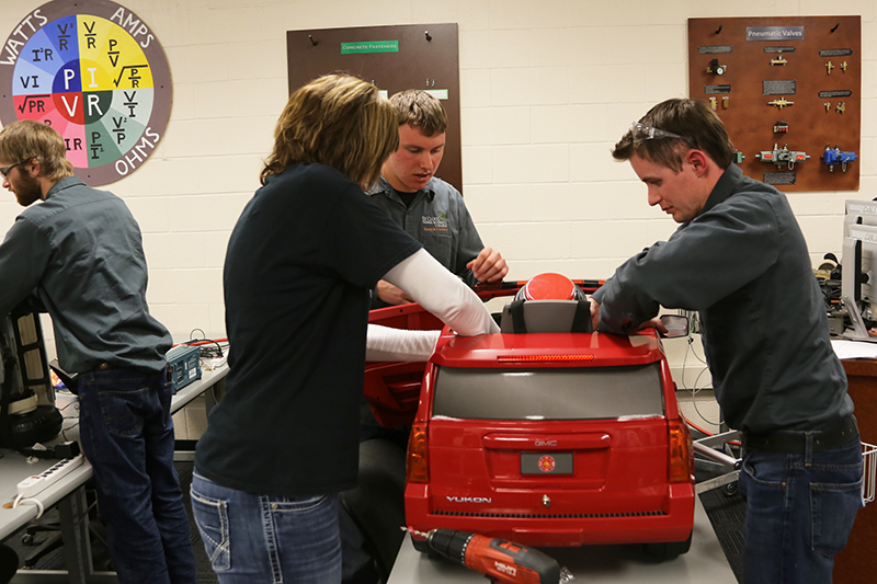 Energy and Electronics students working on red car