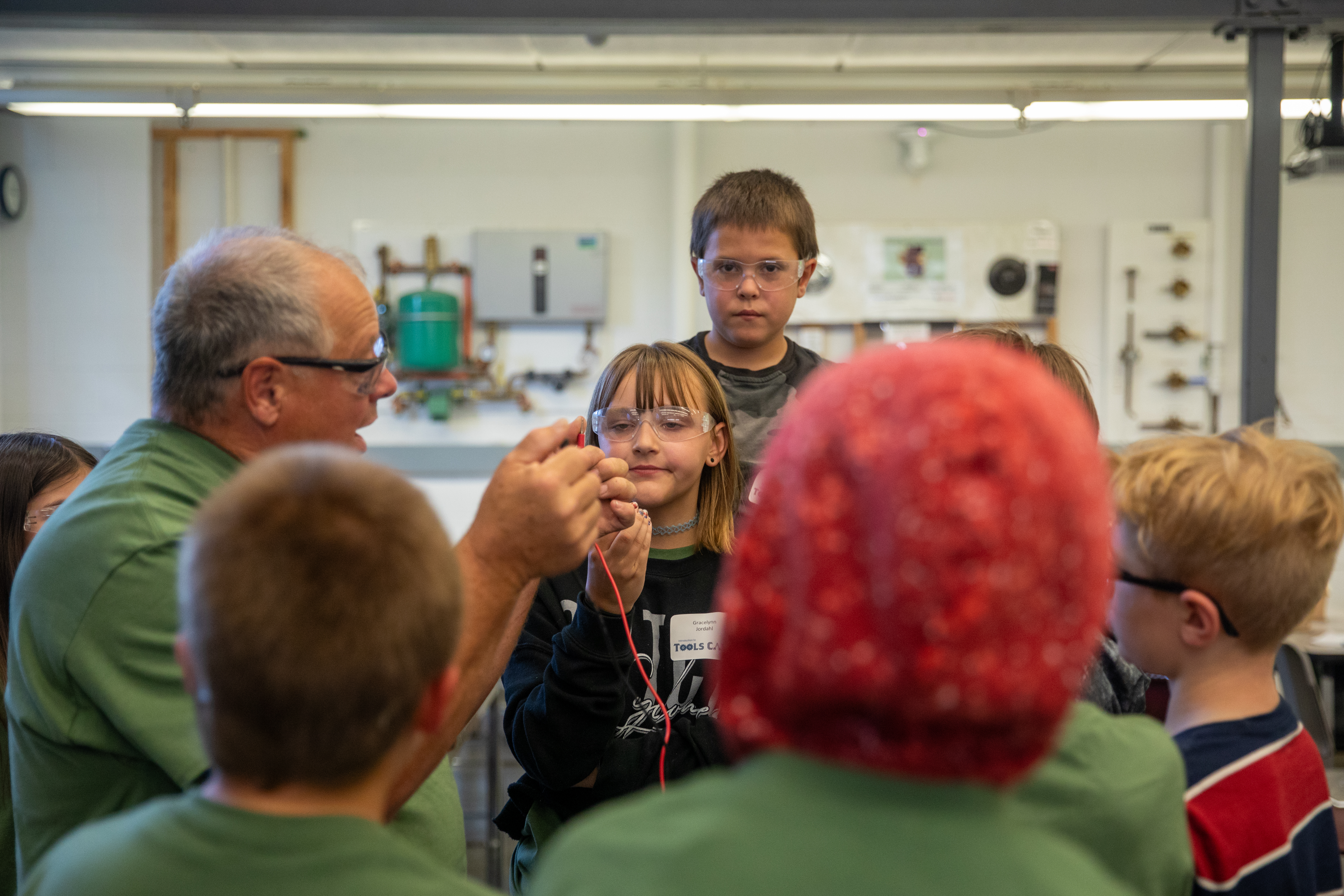 campers gathered in a group, learning about wiring