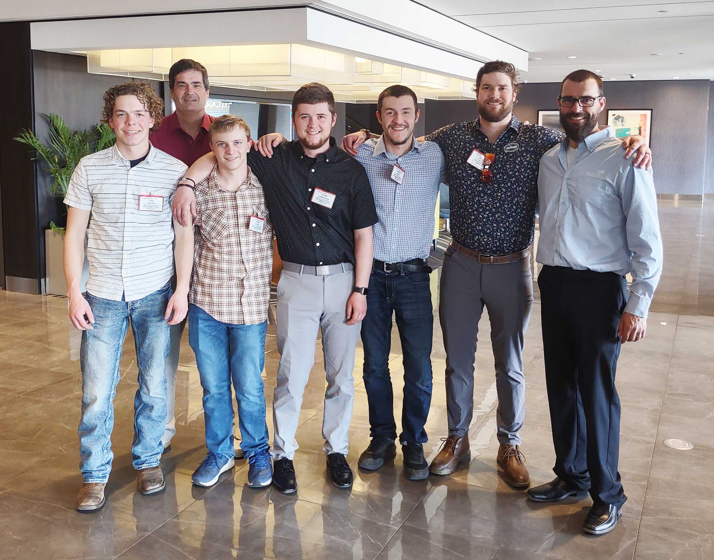 6 electrical students and instructor smiling at camera