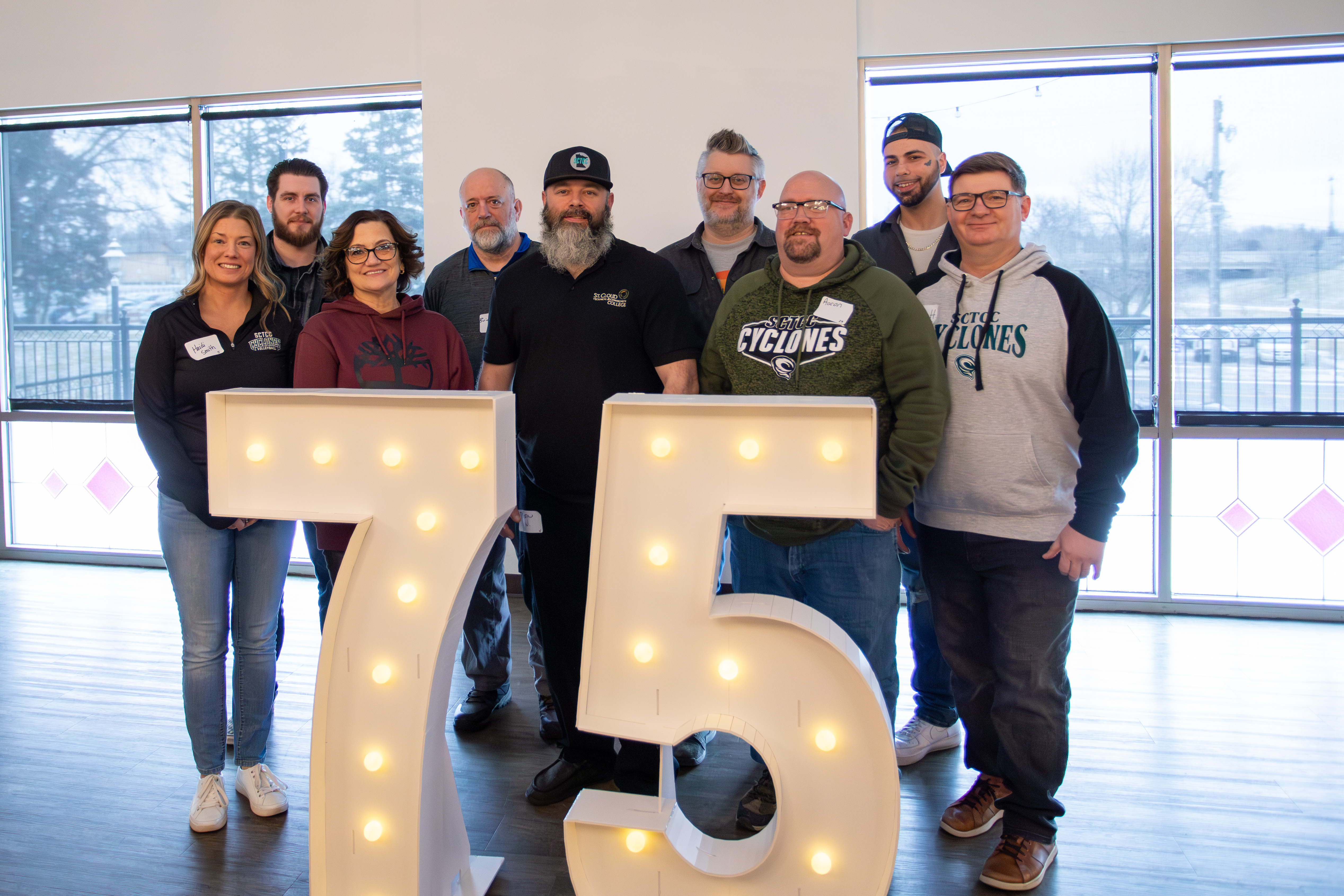group of veteran employees with 75 sign